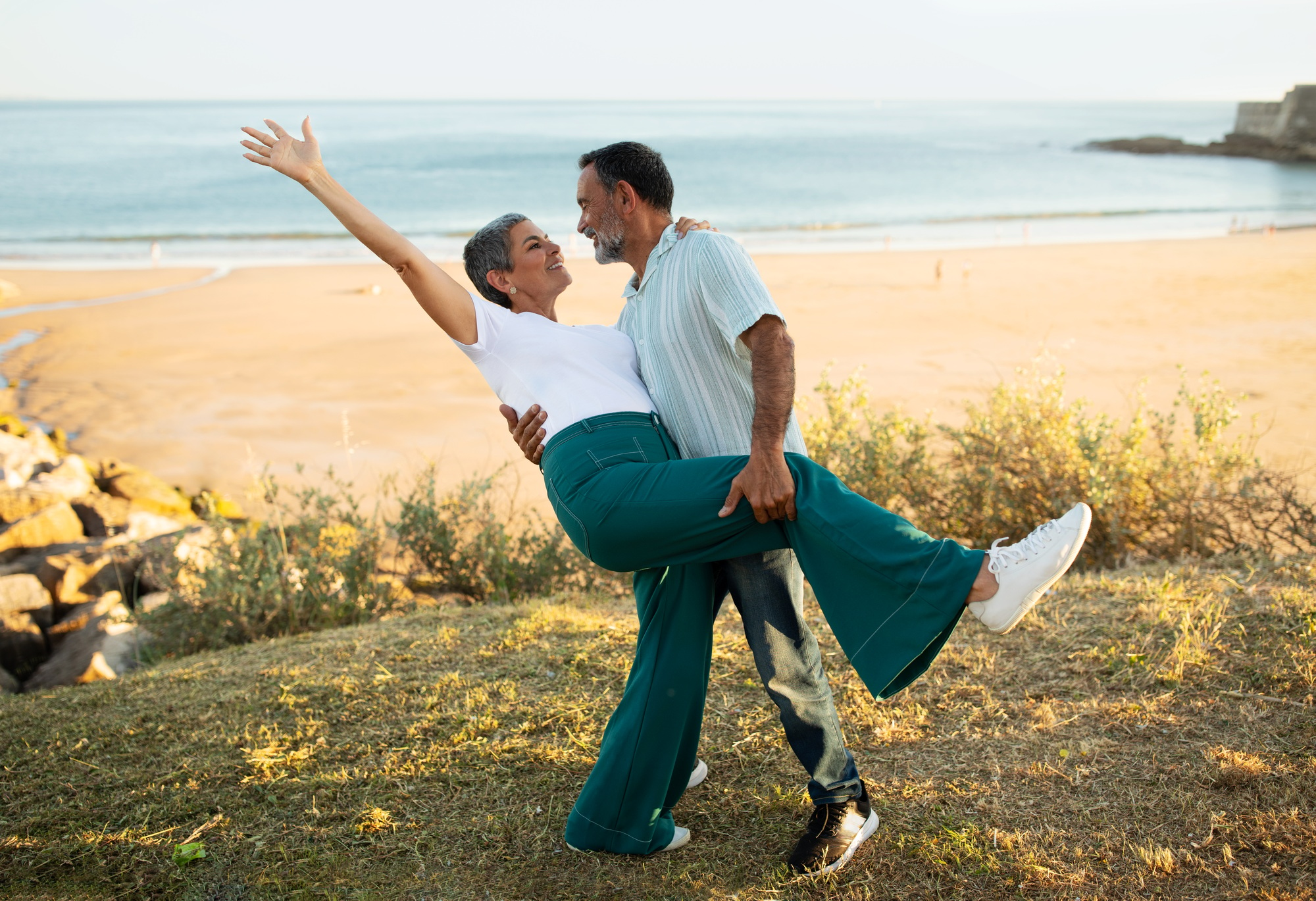 European Senior Couple Dancing Having Fun At Ocean Beach Outside